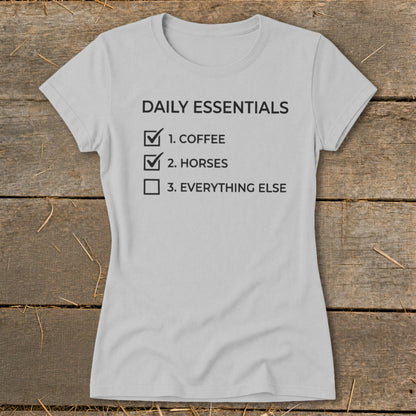 Grey t-shirt with "Daily Essentials" and a checklist including coffee and horses.