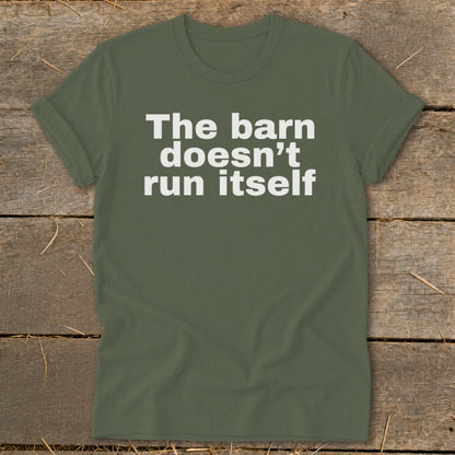 Green t-shirt with white text reading "The barn doesn't run itself".
