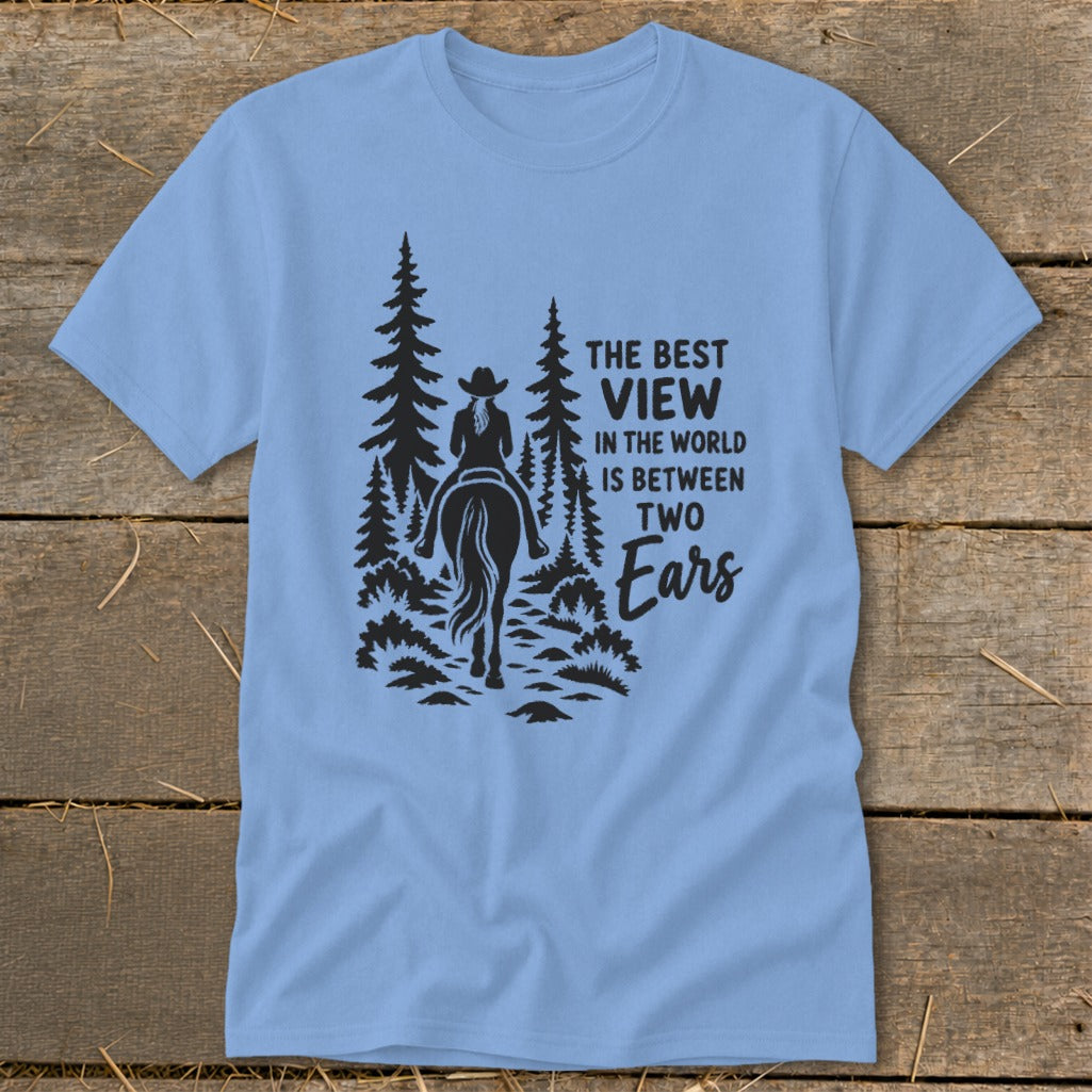 Light blue crewneck t-shirt featuring a black silhouette graphic of a horseback rider in the woods with text.