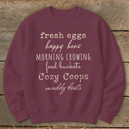 Maroon sweatshirt with white text listing farm-related phrases.