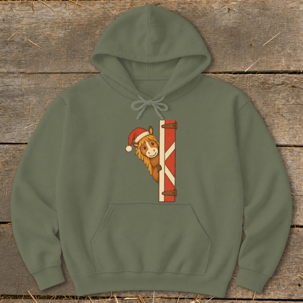 Green hoodie with a Christmas-themed horse peeking from a red and white stable door.