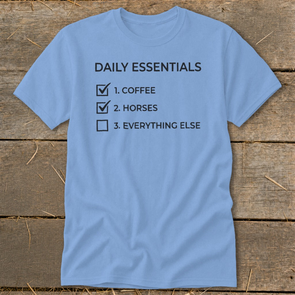 Light blue t-shirt with "Daily Essentials" checklist: Coffee, Horses, Everything Else.