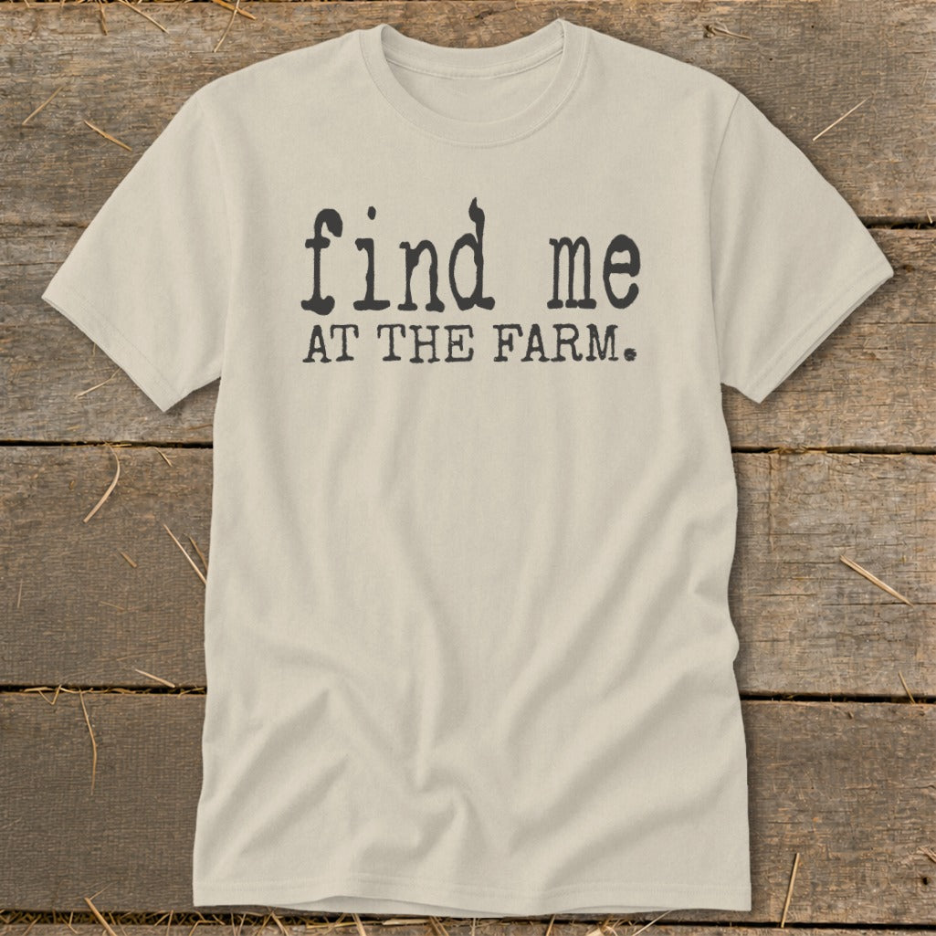 Light beige t-shirt with black text that reads "find me AT THE FARM."