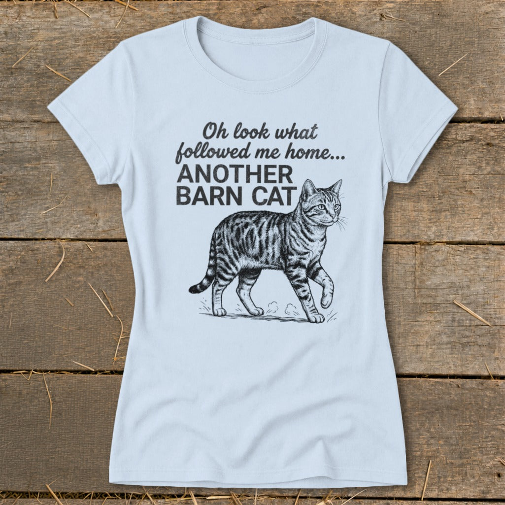 Light blue t-shirt with a graphic of a tabby cat and text reading "Oh look what followed me home... ANOTHER BARN CAT".