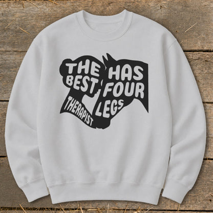 White sweatshirt with a black graphic that reads "The best therapist has four legs."