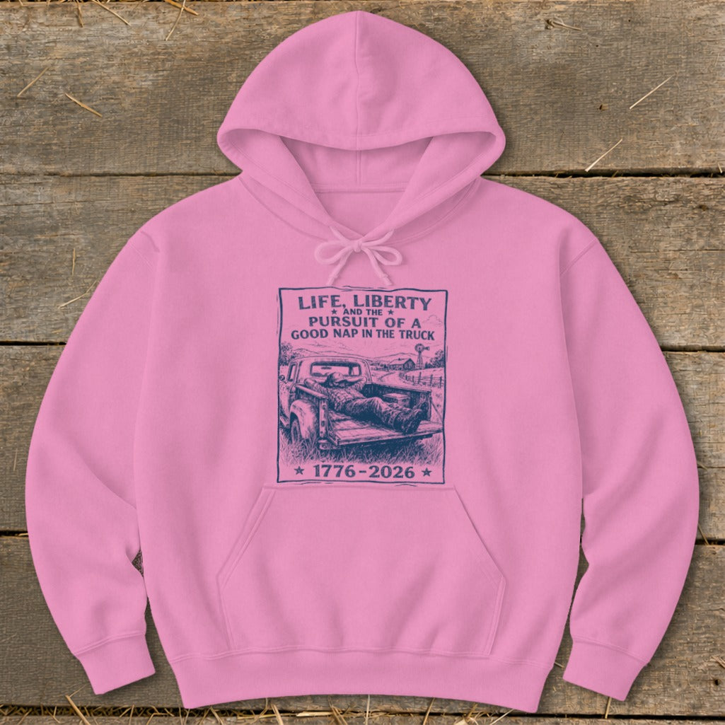 Pink hoodie with "Life, Liberty and the Pursuit of a Good Nap in the Truck 1776-2026" text.