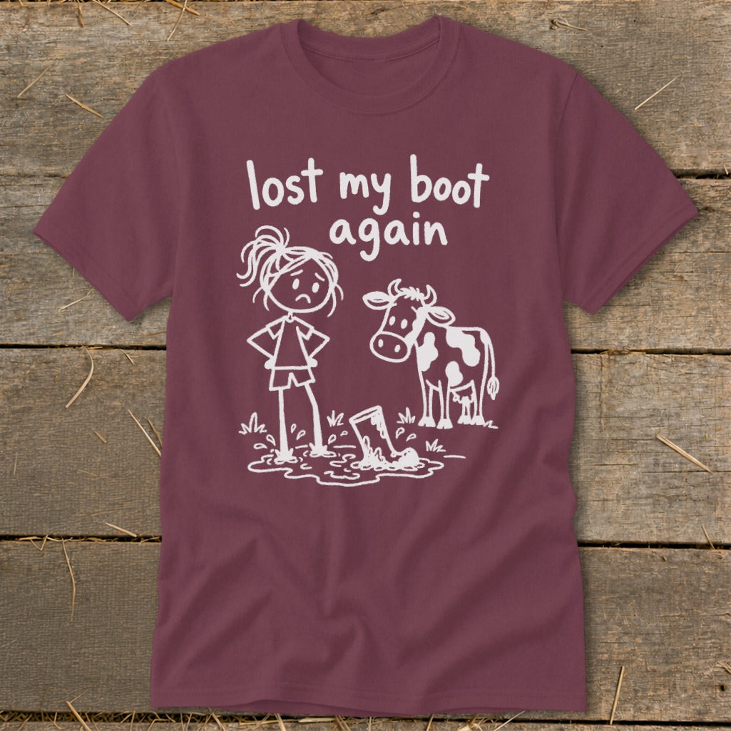 Maroon t-shirt with white graphic text "lost my boot again" and a cartoon girl and cow.