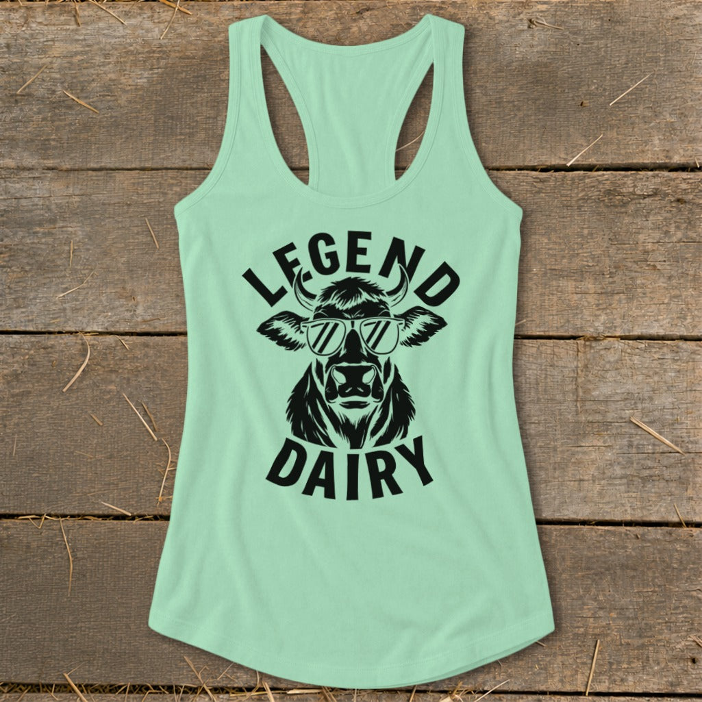 Mint green tank top with black graphic of a cow wearing sunglasses and text "LEGEND DAIRY".