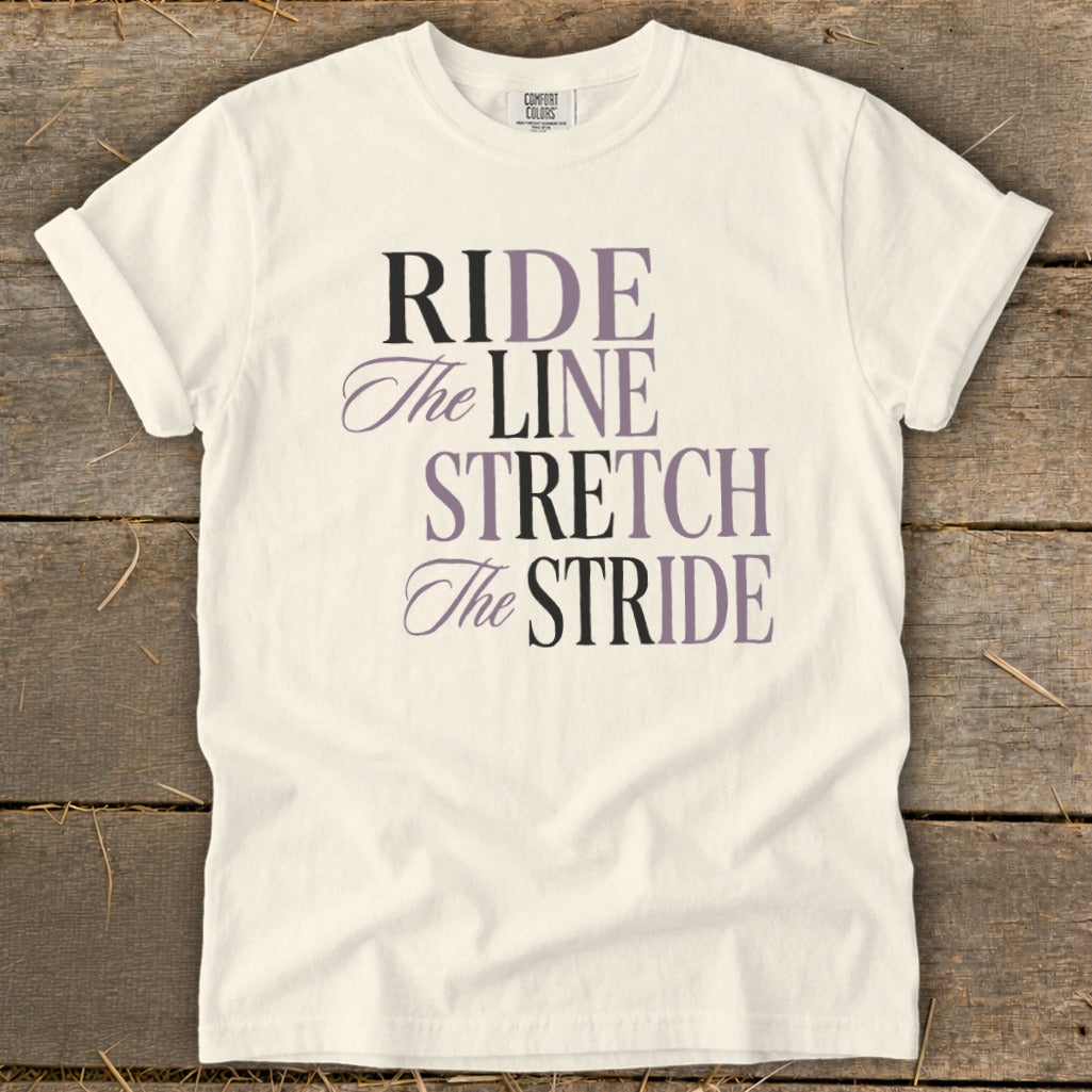 Cream t-shirt with "RIDE The LINE STRETCH The STRIDE" text in purple and black.