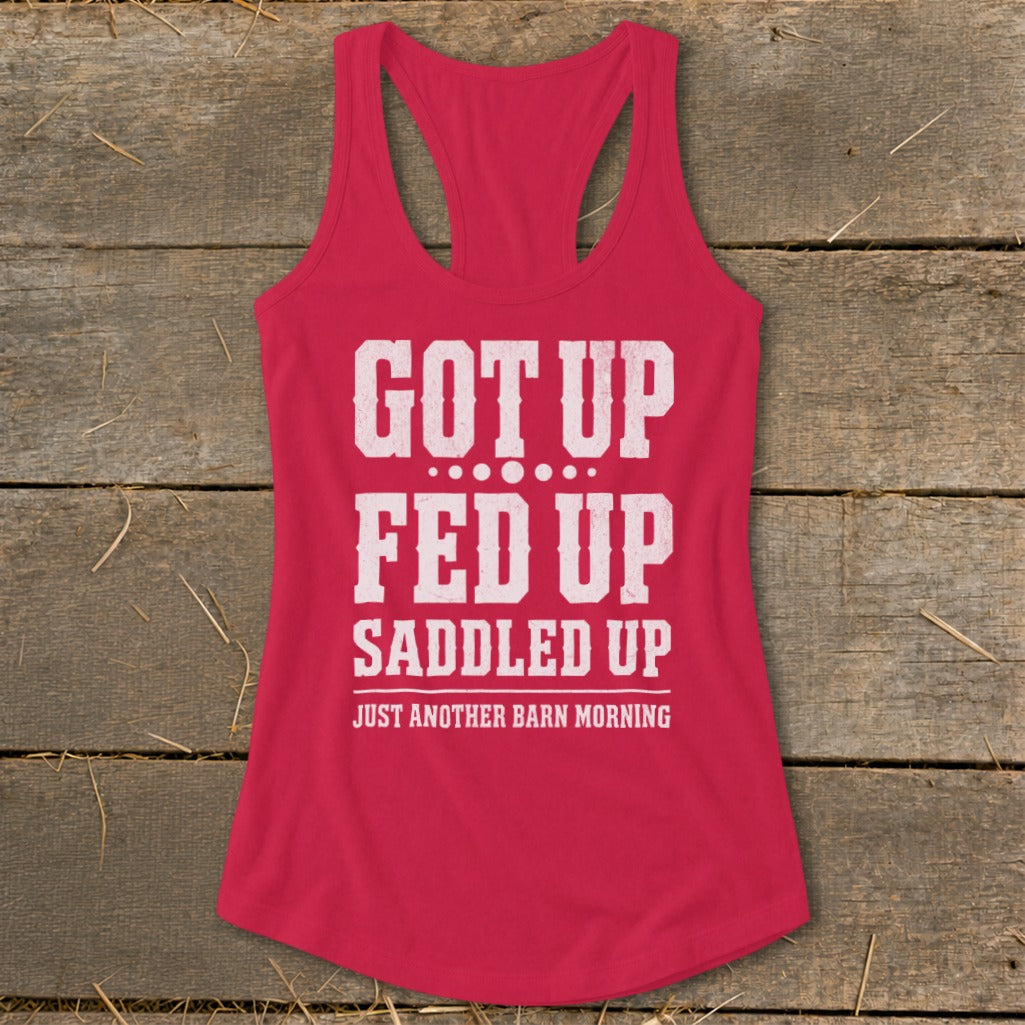 Pink racerback tank top with white text reading "GOT UP FED UP SADDLED UP JUST ANOTHER BARN MORNING".