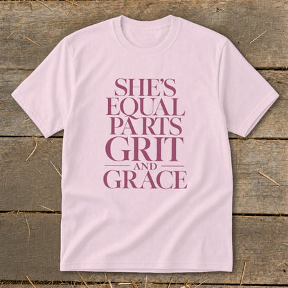Pink t-shirt with purple text "She's Equal Parts Grit and Grace".