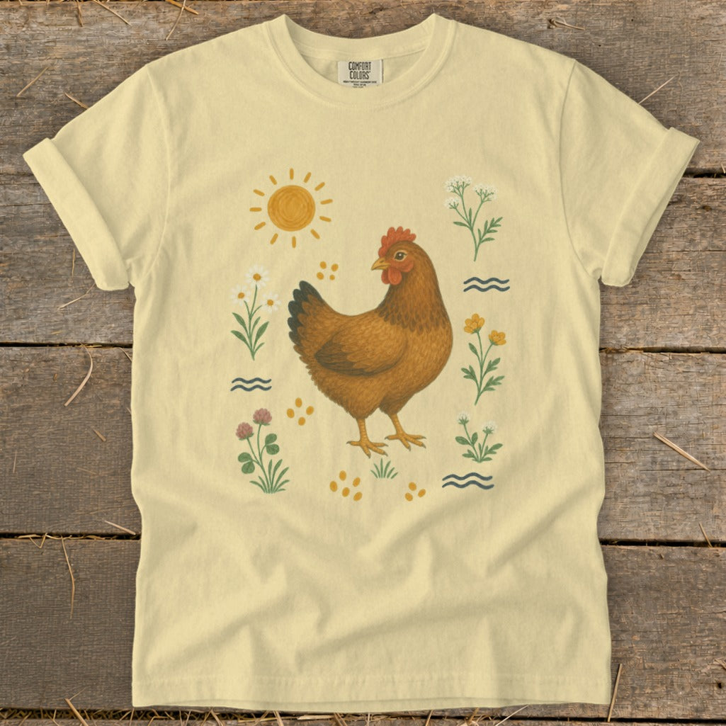Yellow t-shirt with a brown chicken and floral illustration, featuring a sun.