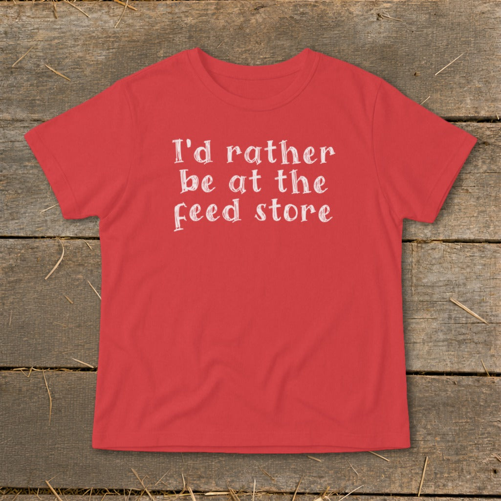 Red t-shirt with white text reading "I'd rather be at the feed store".