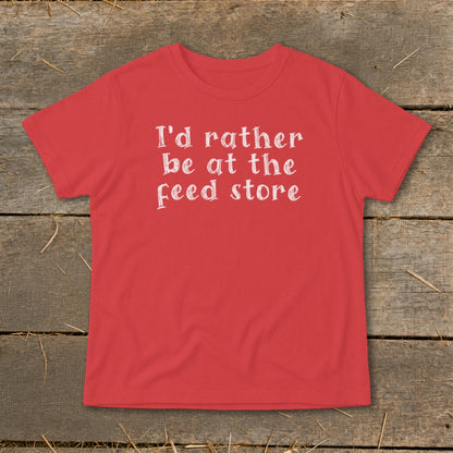Red t-shirt with white text reading "I'd rather be at the feed store".