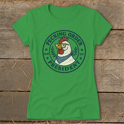 Green t-shirt with a circular graphic of a chicken wearing glasses and a bandana, labeled "Pecking Order President".