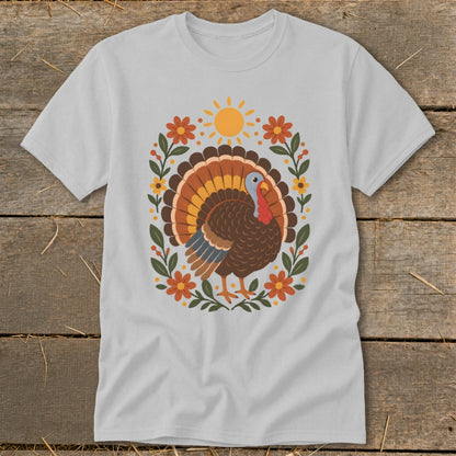 Gray t-shirt with a colorful turkey graphic surrounded by flowers and a sun.