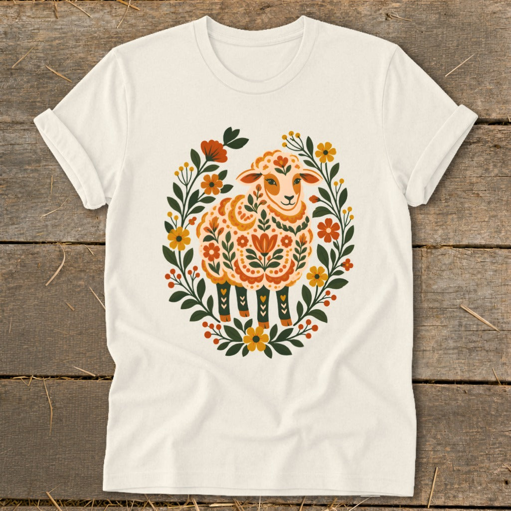 Cream t-shirt with a stylized sheep surrounded by a floral wreath.