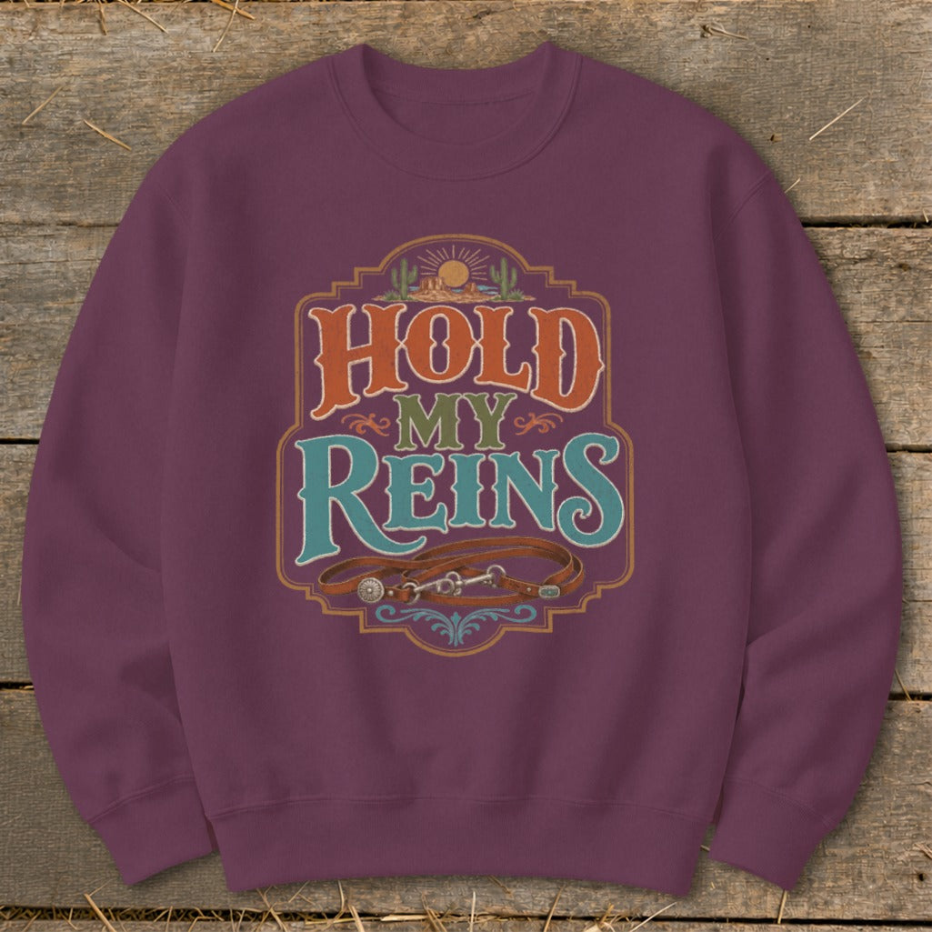 Maroon sweatshirt with "Hold My Reins" text and horse tack graphic.