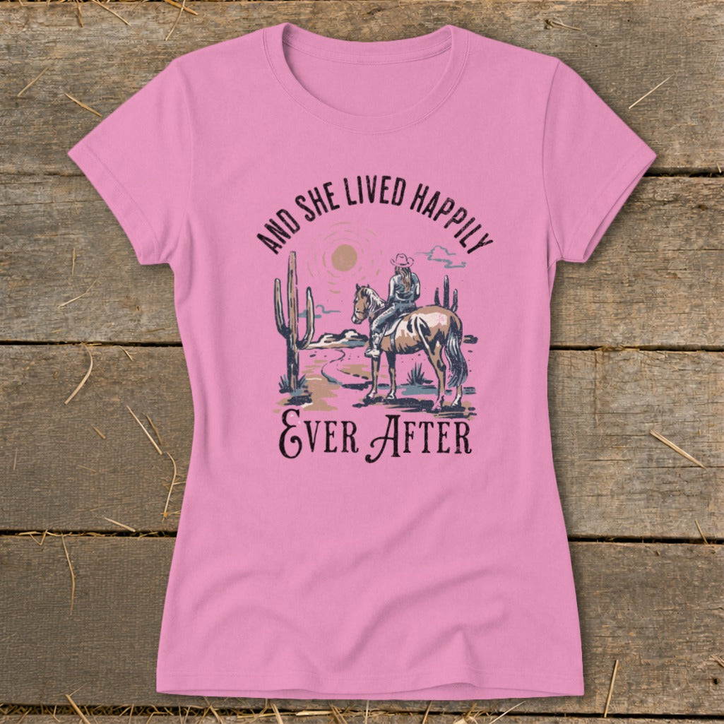 Pink t-shirt with desert graphic and text: "And She Lived Happily Ever After."