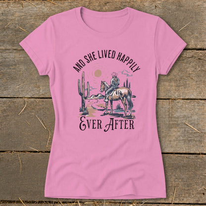 Pink t-shirt with desert graphic and text: "And She Lived Happily Ever After."