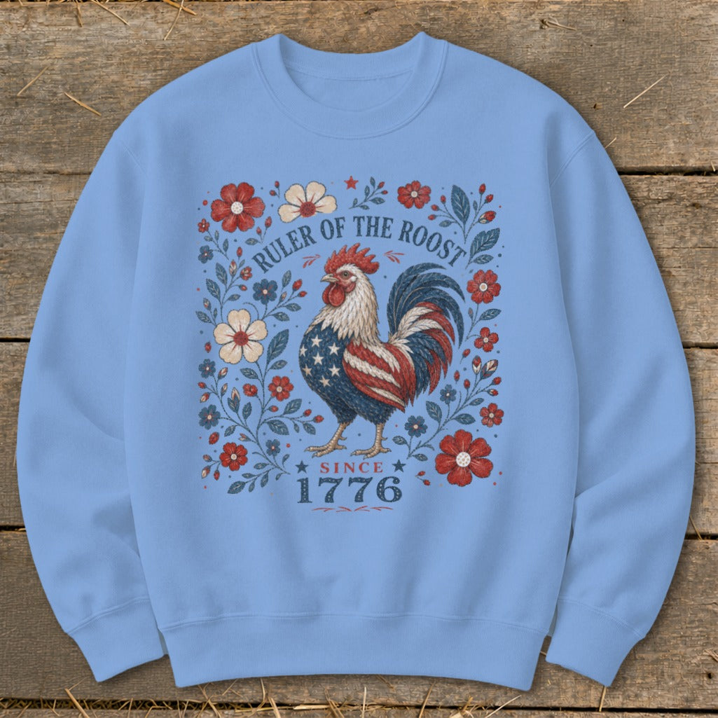 Light blue sweatshirt with a patriotic rooster and floral design, "Ruler of the Roost Since 1776".