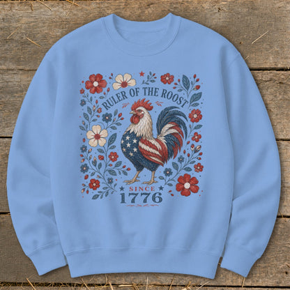Light blue sweatshirt with a patriotic rooster and floral design, "Ruler of the Roost Since 1776".