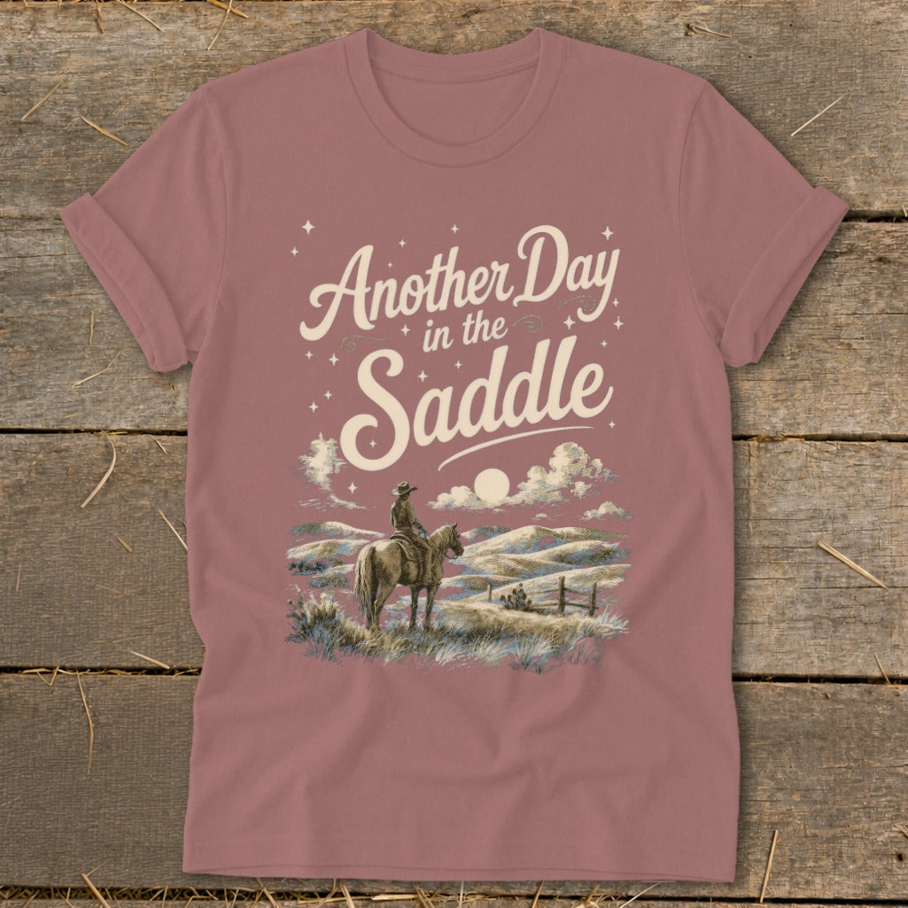 T-shirt with "Another Day in the Saddle" text and cowboy on horseback illustration.