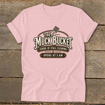 Pink t-shirt with The Muck Bucket School of Stall Cleaning logo.