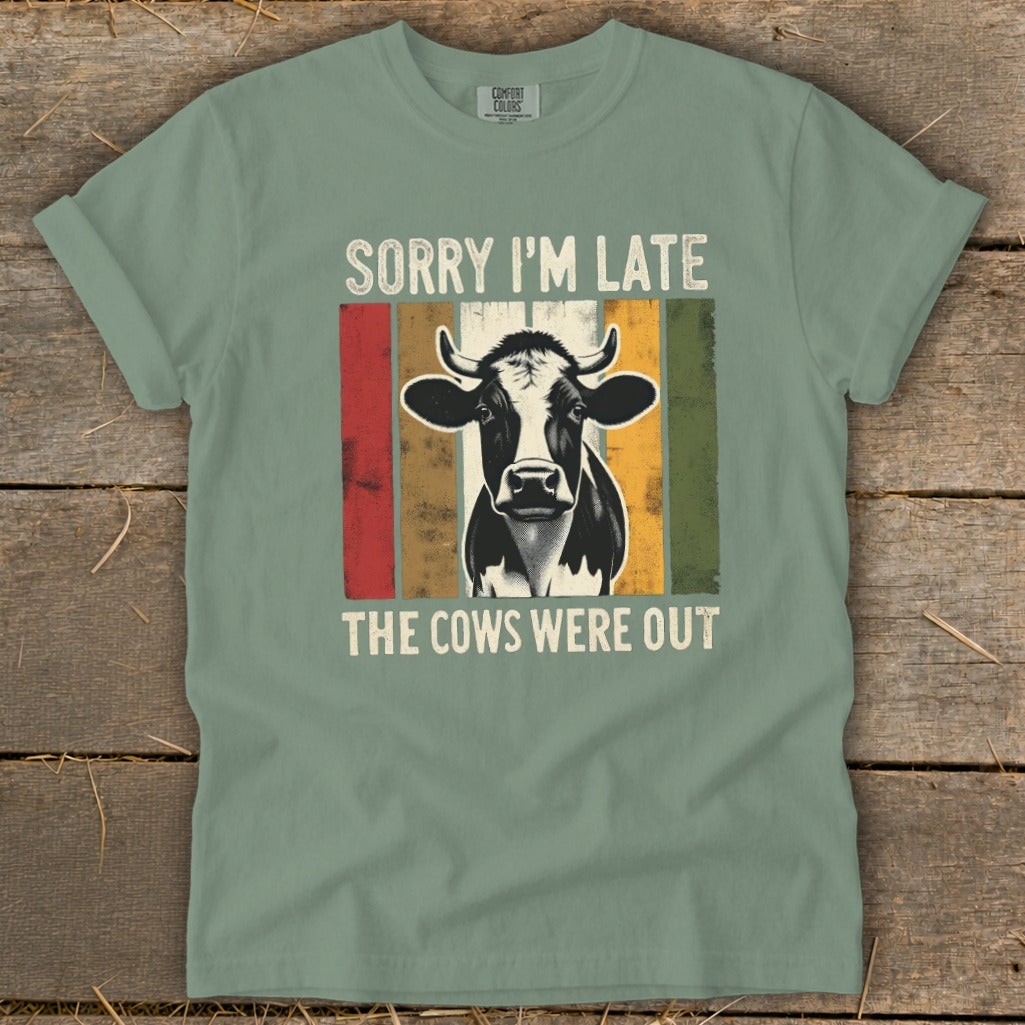 Green t-shirt with distressed cow graphic and text "Sorry I'm Late The Cows Were Out".