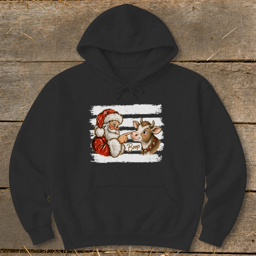 Santa Claus boops a cow with the word "Boop" on a striped background.