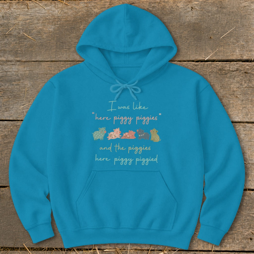 Blue hoodie with text and illustration of five colorful pigs.