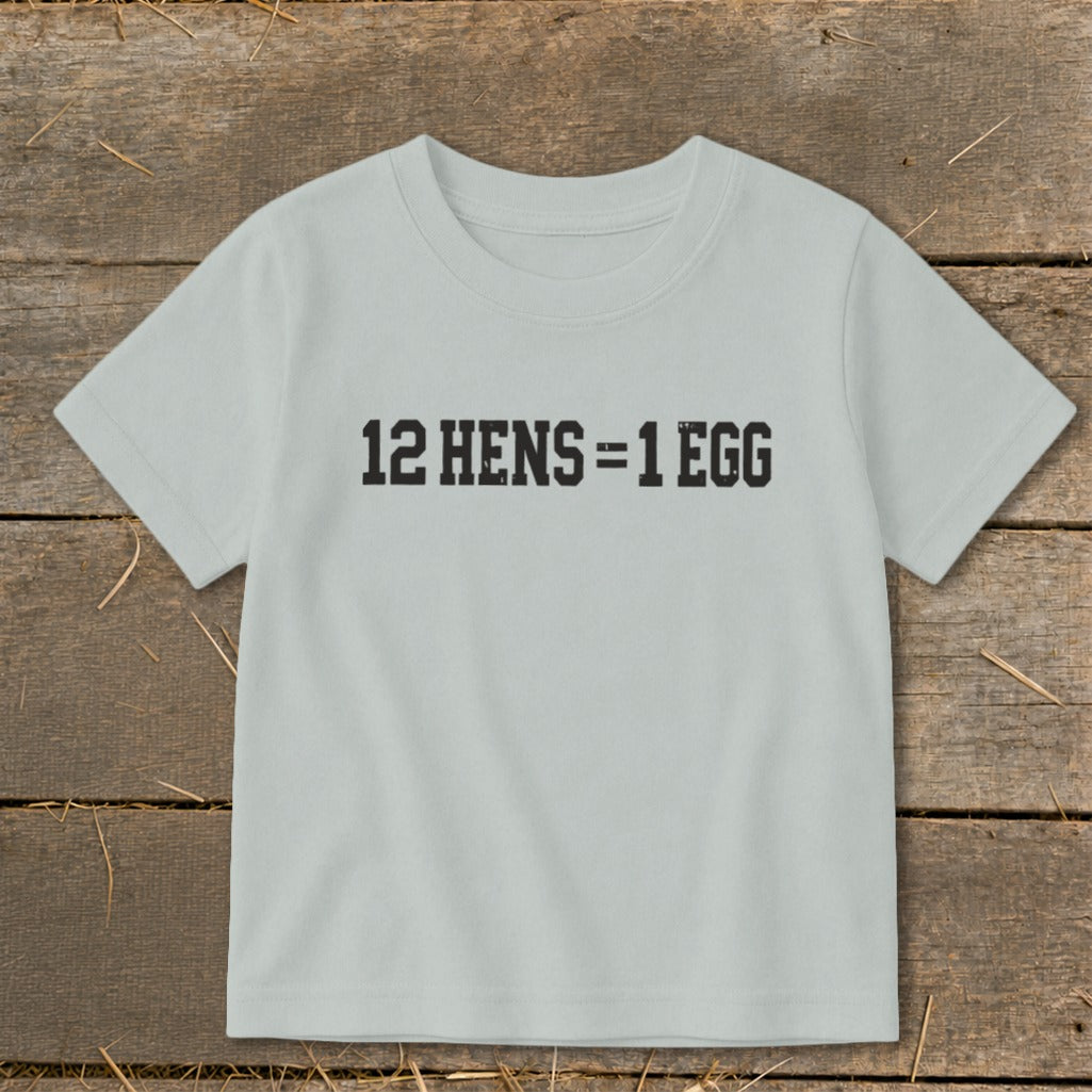 A light gray short-sleeved child's t-shirt printed with the text 12 HENS = 1 EGG.
