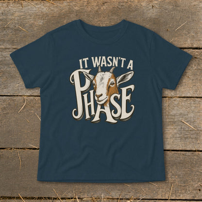 Dark blue t-shirt with a goat graphic and text "IT WASN'T A PHASE".