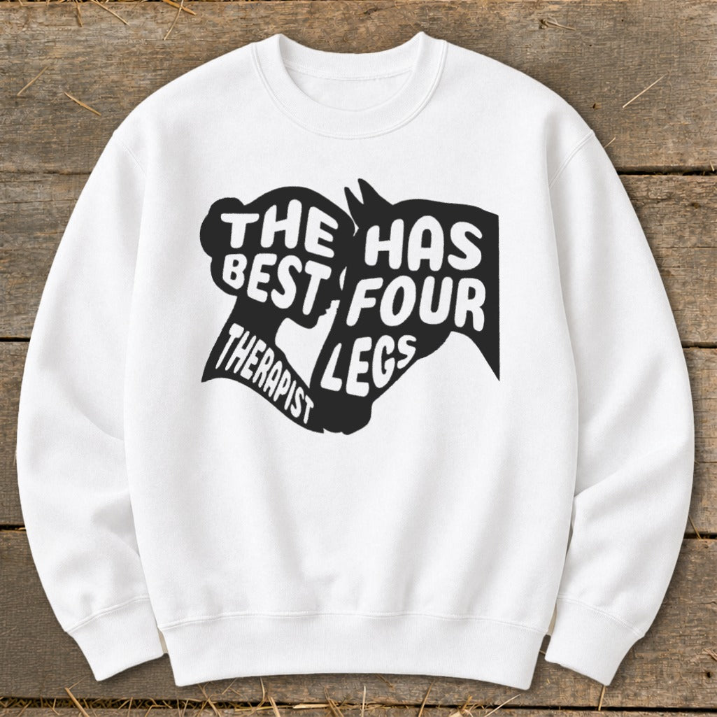 White sweatshirt with black text and horse graphic reading "THE BEST THERAPIST HAS FOUR LEGS."