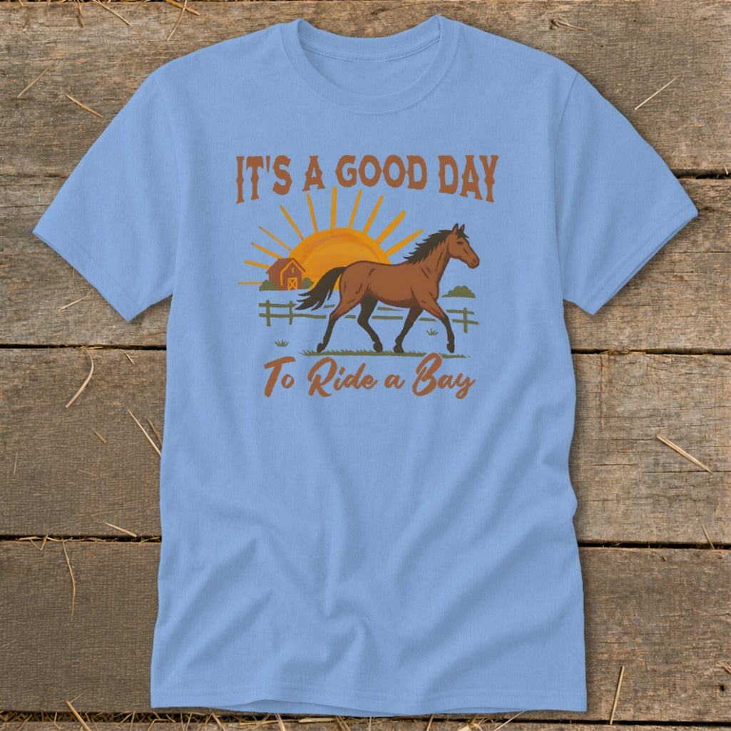 Light blue t-shirt with "It's a Good Day To Ride a Bay" text and horse graphic.
