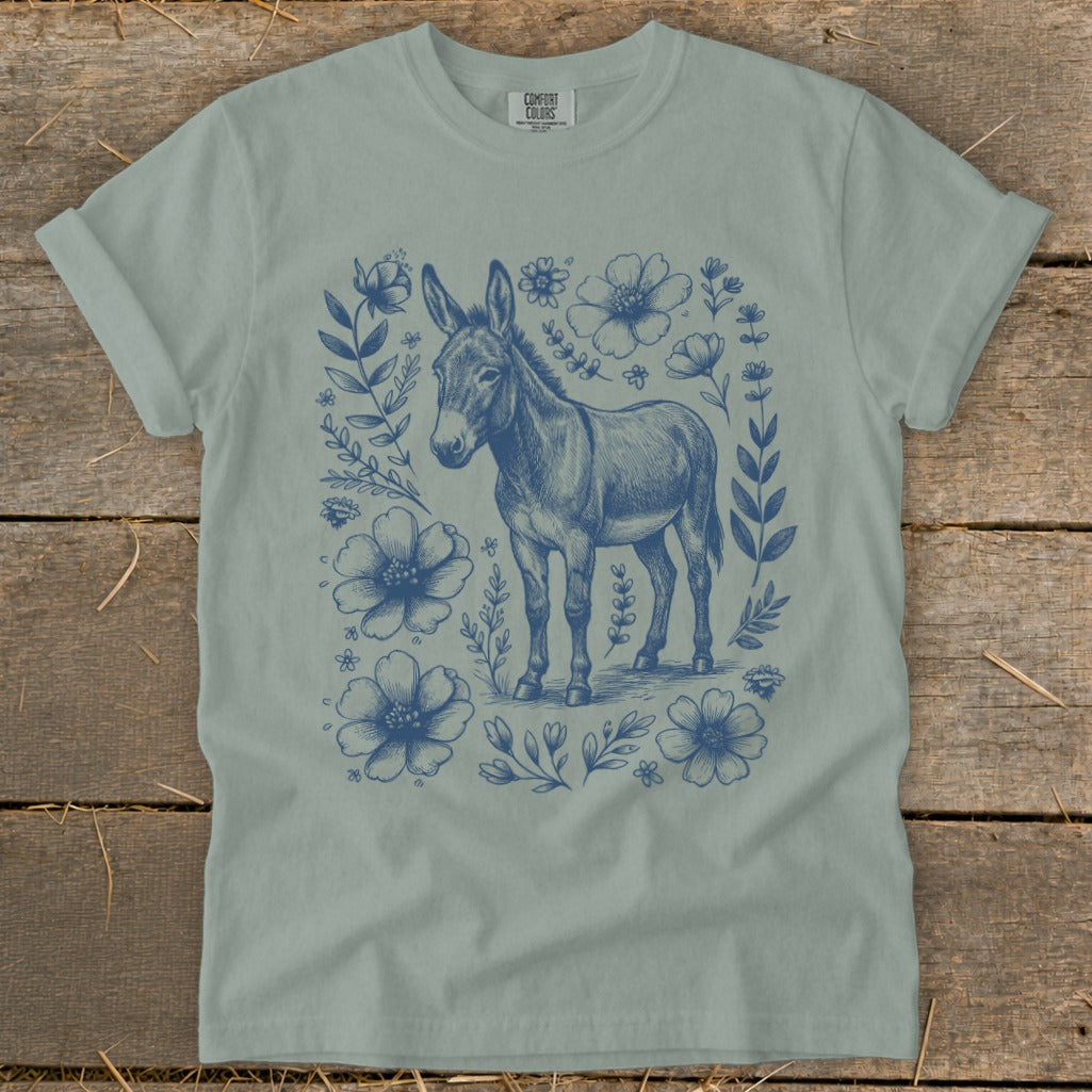 Donkey with blue floral wreath on a light green t-shirt.