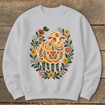 Light gray sweatshirt with a folk art style sheep surrounded by flowers.