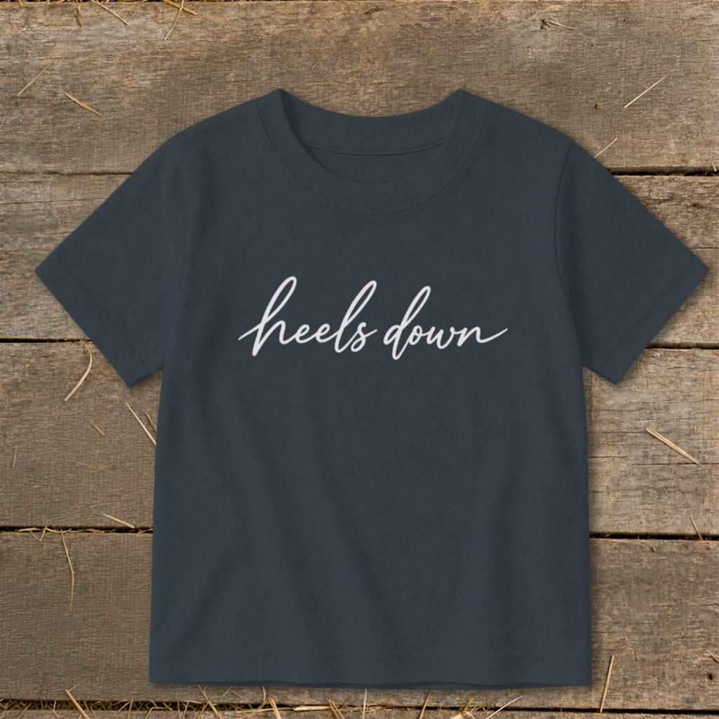 Dark grey t-shirt with white "heels down" text in cursive.