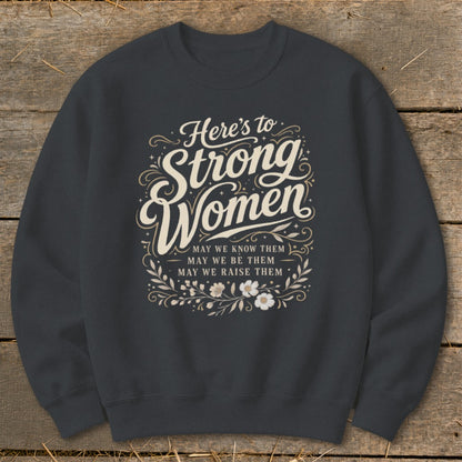 Dark gray sweatshirt with "Here's to Strong Women" and inspirational text.