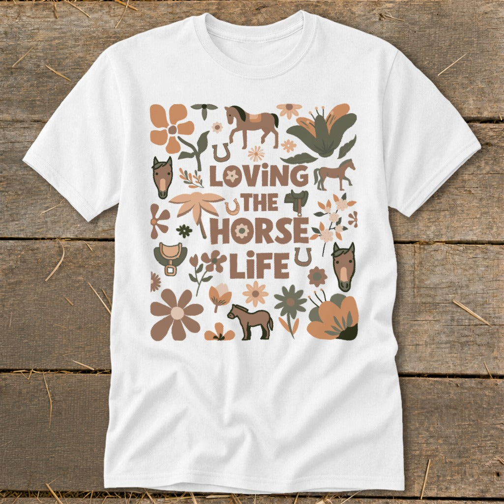 White t-shirt with "Loving The Horse Life" text surrounded by horse and floral graphics.