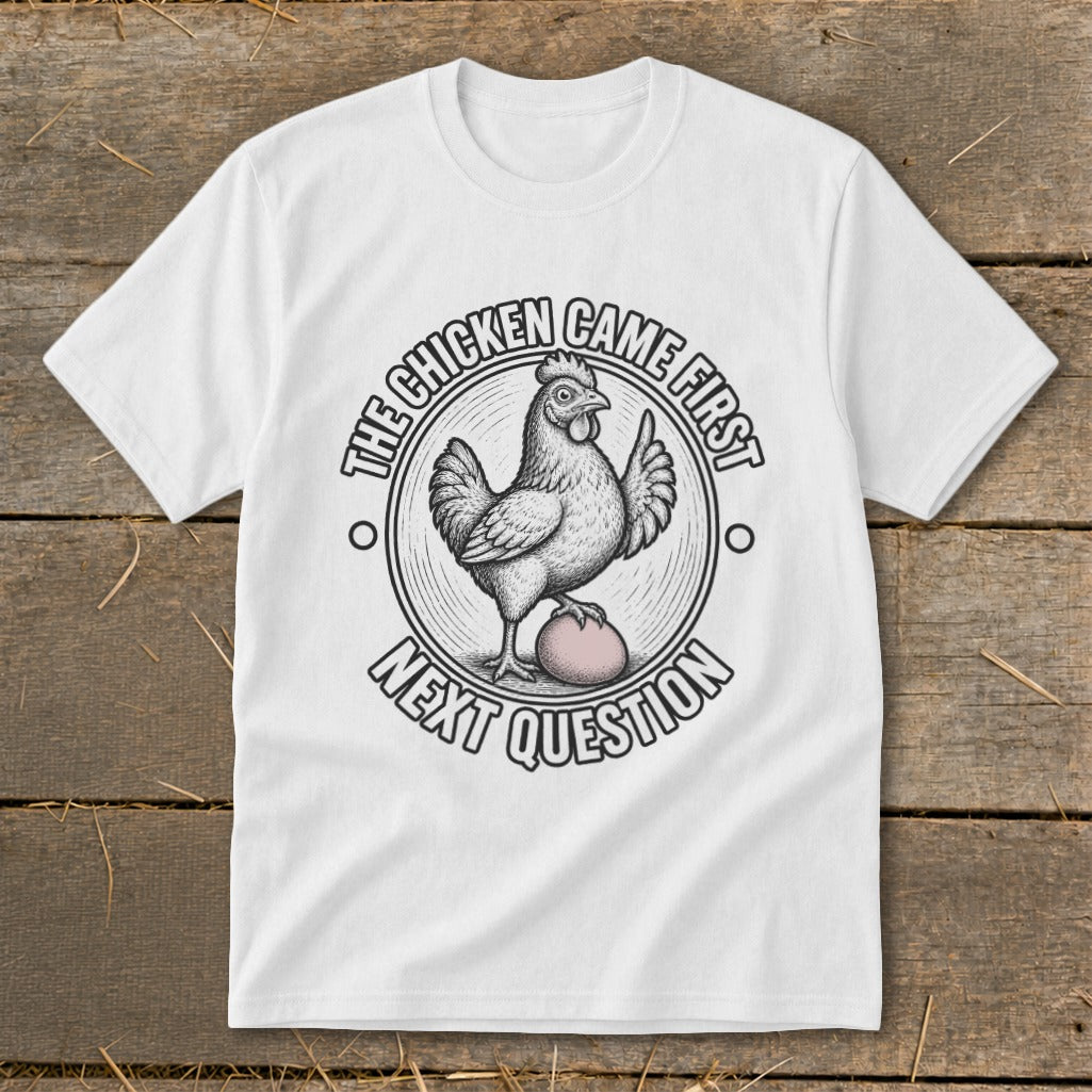 White t-shirt with chicken and egg graphic, saying "The Chicken Came First Next Question".