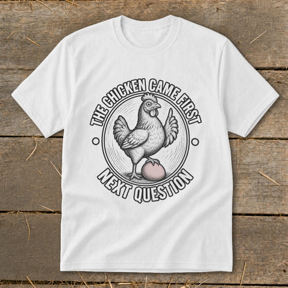 White t-shirt with chicken and egg graphic, saying "The Chicken Came First Next Question".