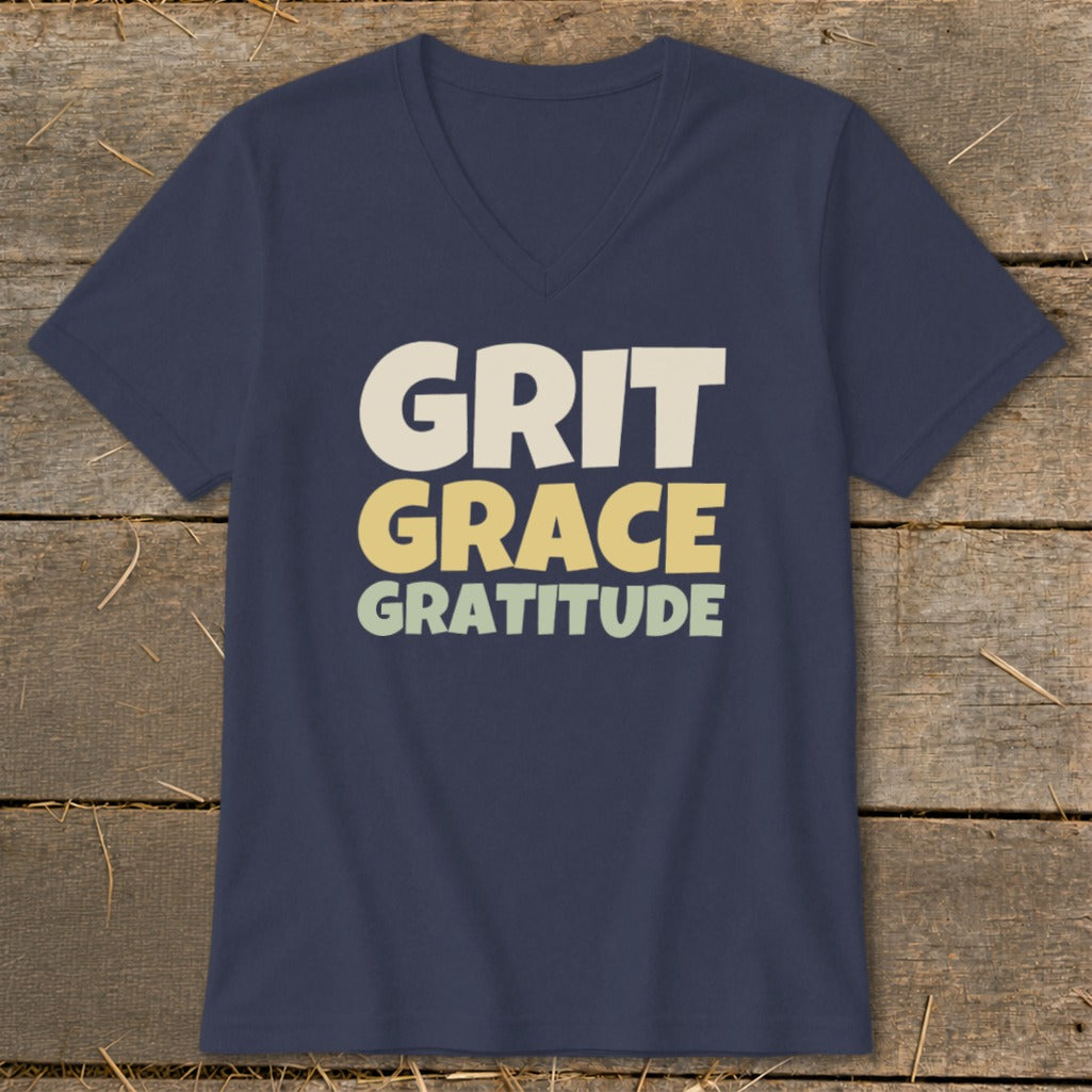 A dark blue V-neck t-shirt with the words Grit, Grace, and Gratitude printed on the front.