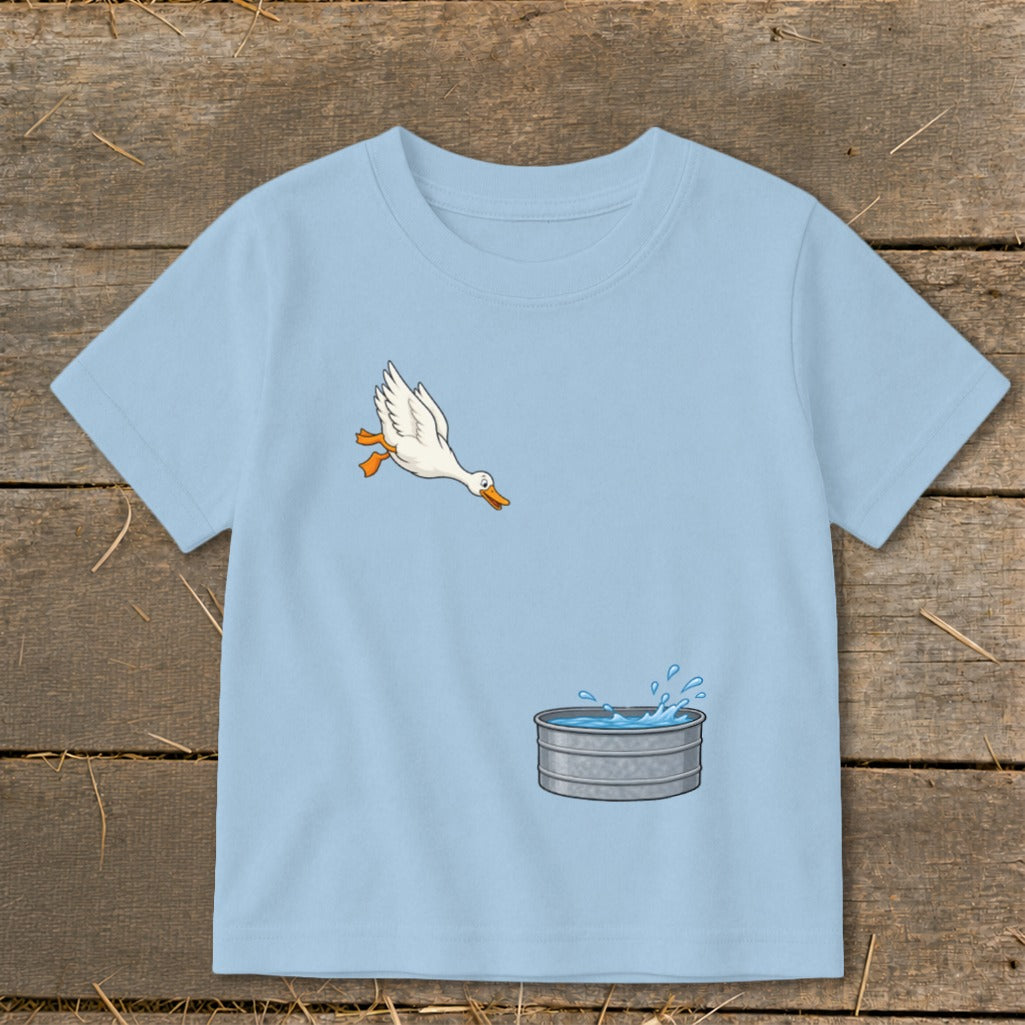 Light blue t-shirt with cartoon duck jumping into water trough graphic.