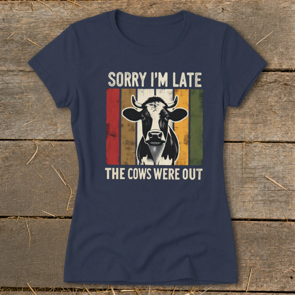 Navy t-shirt with a cow graphic and text "SORRY I'M LATE THE COWS WERE OUT".