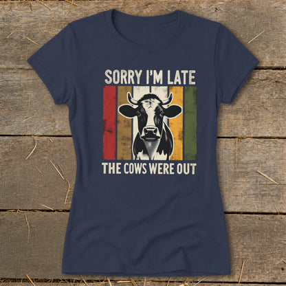 Navy t-shirt with a cow graphic and text "SORRY I'M LATE THE COWS WERE OUT".
