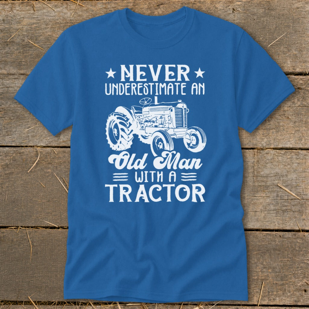 Blue t-shirt with white graphic: Never Underestimate an Old Man with a Tractor.