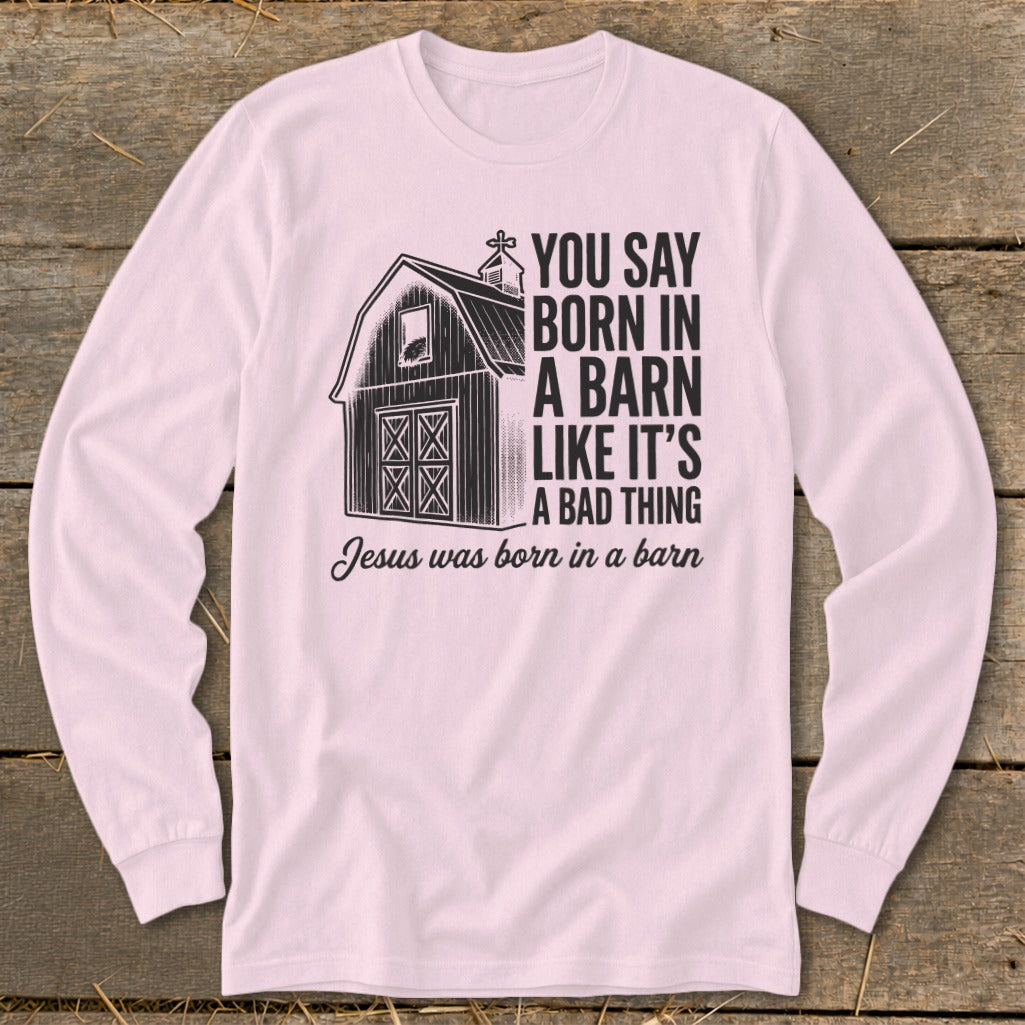 Light pink long sleeve shirt with barn graphic and text about Jesus.