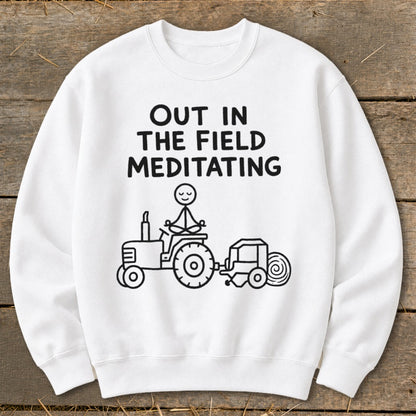 White sweatshirt with black text and stick figure drawing of a person meditating on a tractor.