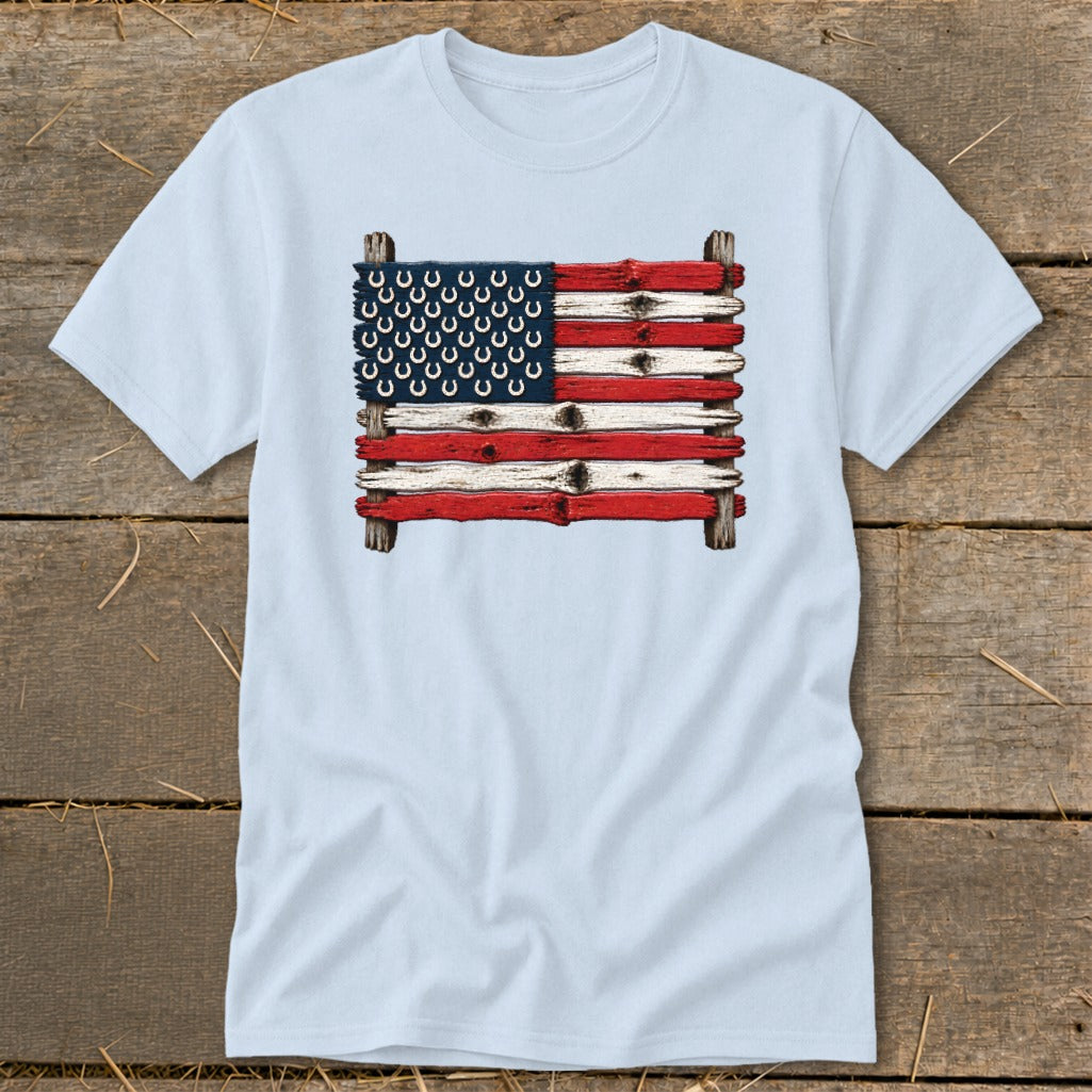 Light blue t-shirt featuring a rustic American flag made of painted wood planks with horseshoe stars.